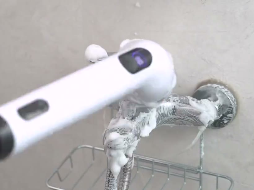 Chrome faucet while the TUYU spin scrubber scrubs